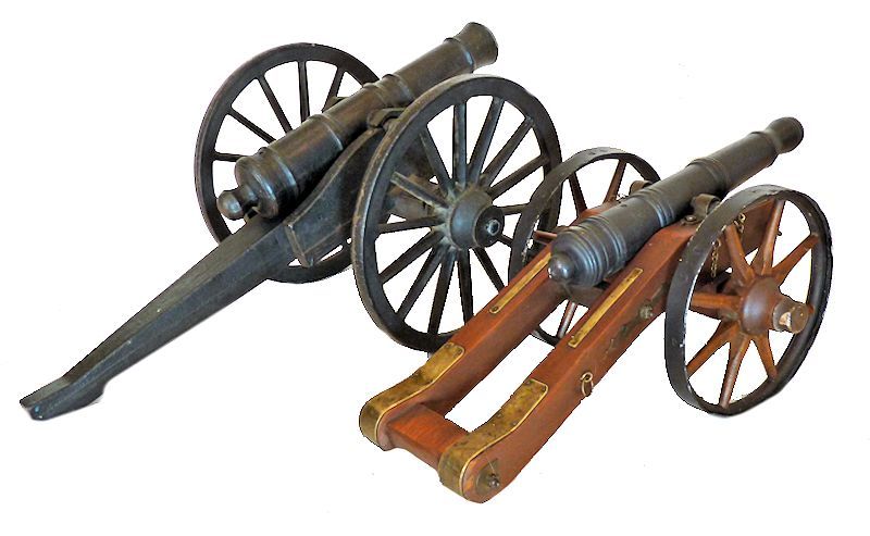 The giant Revolutionar War cast iron cannon shown next to a smaller wood and iron field cannon of the same period image