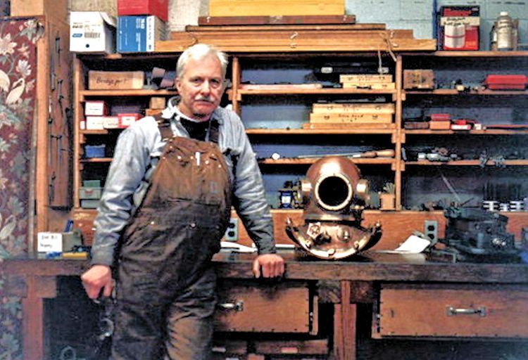 David L. Clark in his shop alongside one of his copper dive hellmets image